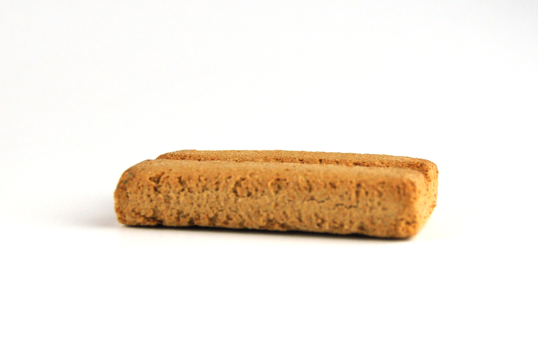 Rechteckiges, goldbraunes Keks, krümelige Textur, seitliche Kanten leicht angekantet.